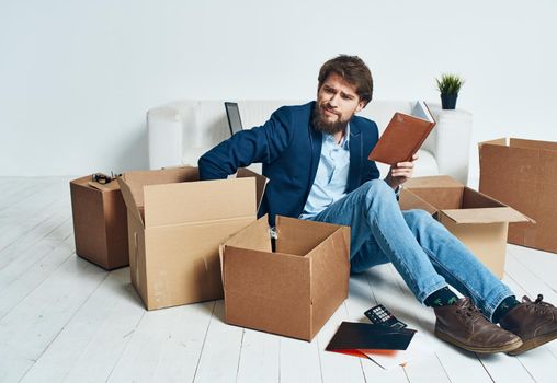 Man at home boxes with things moving work lifestyle. High quality photo