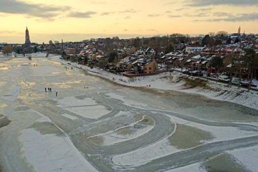 Aerial from the snowy city Rhenen in the Netherlands in winter