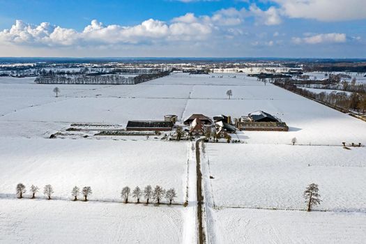 Aerial from a traditional dutch landscape in winter in the Netherlands