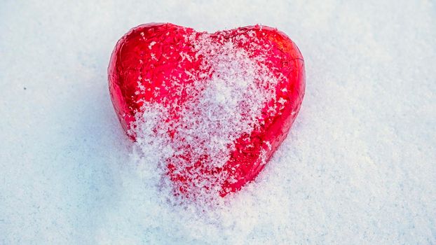 Red Valentine's heart in the snow