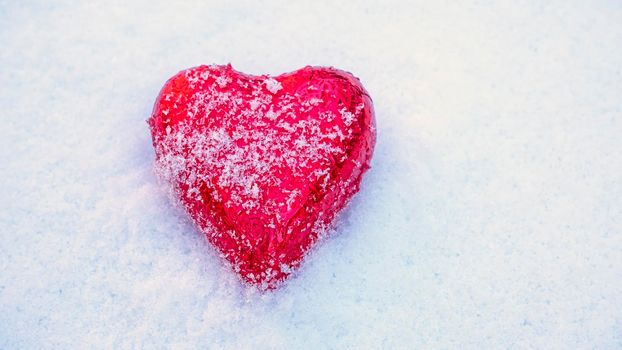Red Valentine's heart in the snow