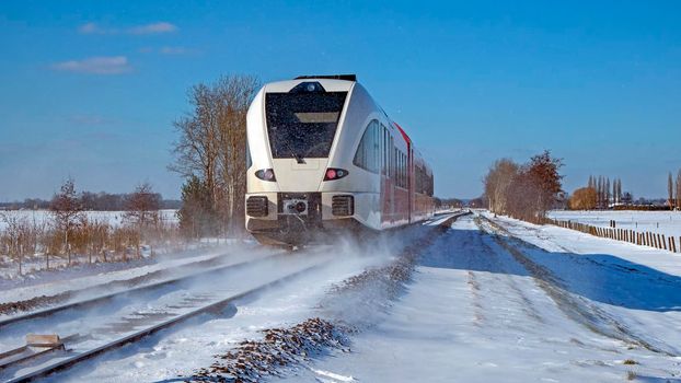 Train driving in the countryside from the Netherlands on a winter day