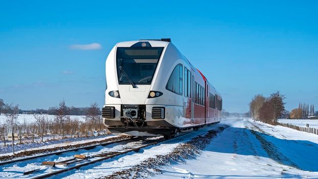 Train driving in the countryside from the Netherlands on a winter day