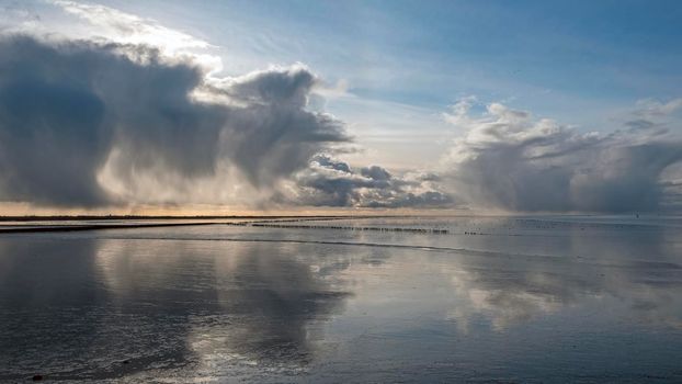 Incredible cloudscape at the Wadden sea near Holwerd in the Netherlands at sunset