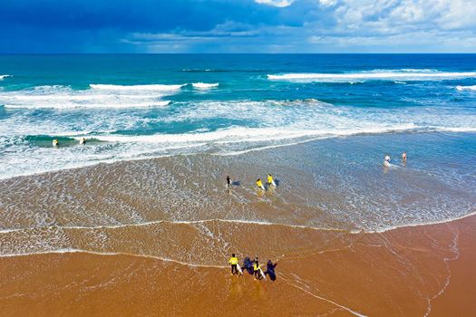 Aerial from surfers getting surfers lessons at Praia Vale Figueiras in Portugal