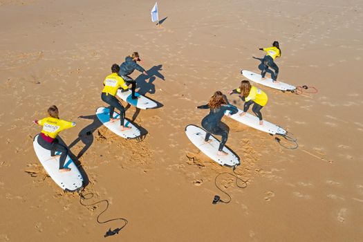 Vale Figueiras, Portugal - January 2, 2021: Surfers getting surflessons at Vale Figueiras beach in Portugal