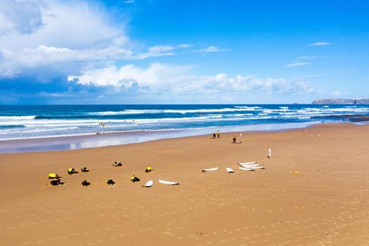 Vale Figueiras, Portugal - January 2, 2021: Surfers getting surflessons at Vale Figueiras beach in Portugal