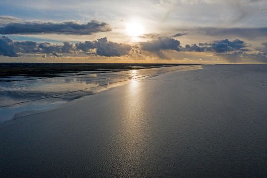 Aerial from the coast line at the Wadden Sea near Holwerd in the Netherlands at sunset