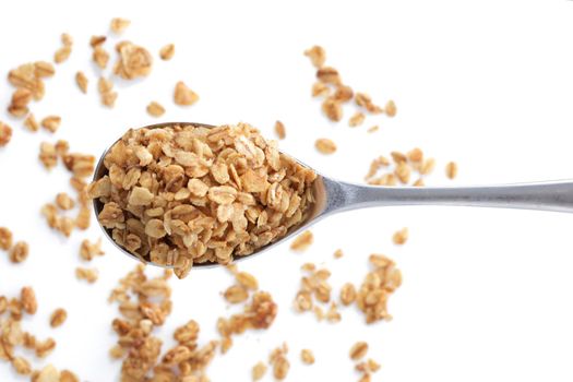 A heap of granola oats on a spoon selective focus