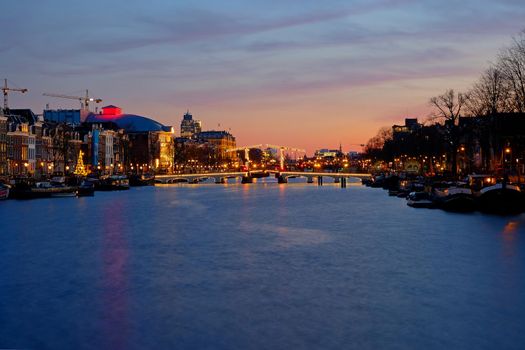 Tiny bridge in Amsterdam the Netherlands at sunset at the Amstel