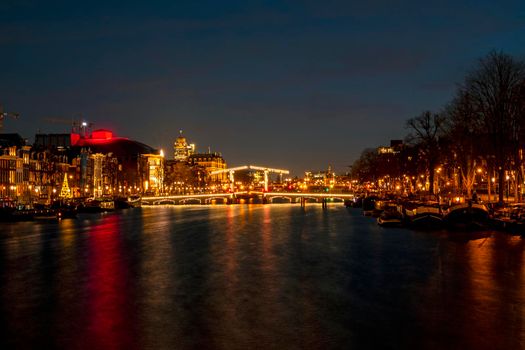 Tiny bridge in Amsterdam the Netherlands at sunset at the Amstel