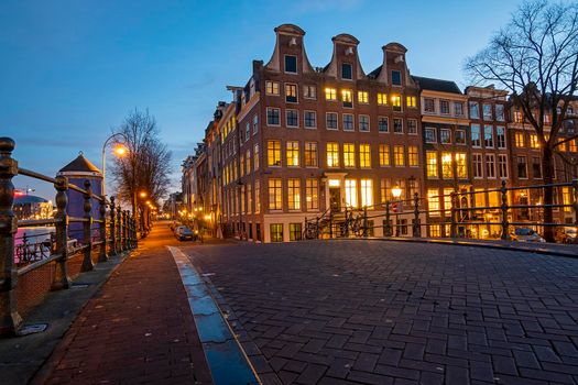 Houses at the Amstel in Amsterdam in the Netherlands at sunset