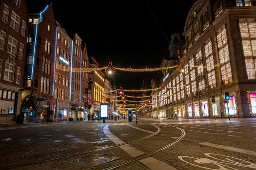 Christmas in Amsterdam at the Damrak at night in the Netherlands