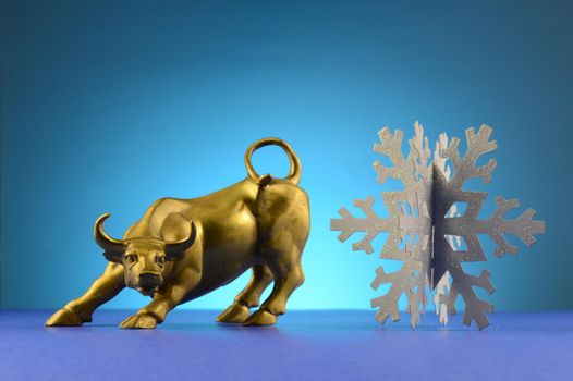 A bull and snowflake over a blue background.