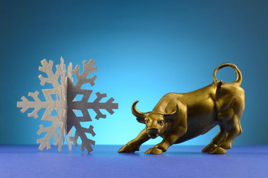 A bull and snowflake over a blue background.