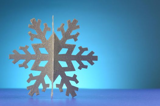 A cool winter snowflake over a blue background.