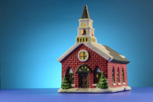 A Christmas nativity church over a blue background.