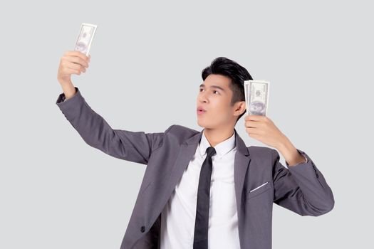 Young asian business man holding money dollar isolated on white background, businessman in suit holding banknote and success and excited with finance, savings and investment, income and spending.