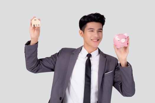Young asian business man holding home and piggy bank for planning saving future, insurance agent and credit, debt and loan of finance, purchase home and refinance, investment about real property.