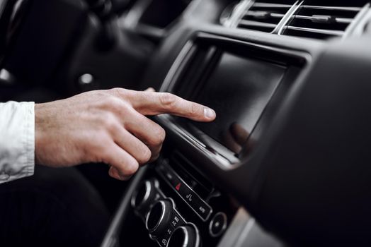 Close up of man using gps navigation system in car to travel. Transportation and vehicle concept