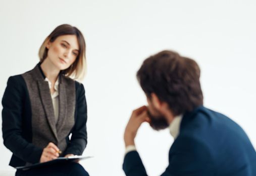 Woman and man in a jacket on a light background job interview. High quality photo