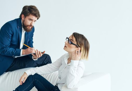 man in suit next to woman businessmen team communicating emotions. High quality photo