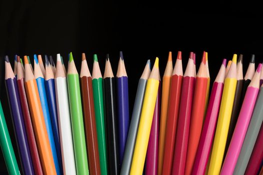 A set of colored pencils, stationery. Lots of colorful pencils on the table. Drawing and Visual Art Kits