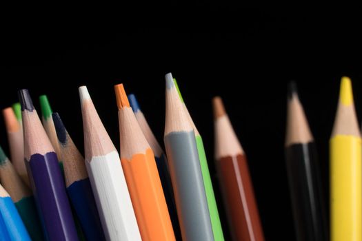 A set of colored pencils, stationery. Lots of colorful pencils on the table. Drawing and Visual Art Kits