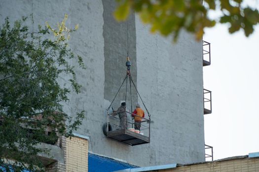 Repair a building, skyscraper, or structure with a crane. Repair of a multi-storey residential building. Prefabricated structures and products.