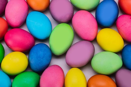 Many colorful easter eggs multicolored close up background top view
