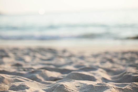 Close up of sand of beach with blurred sea background