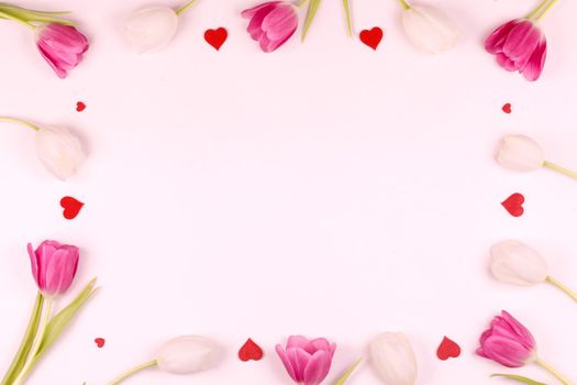 Frame made of colourful tulips and red hearts Valentines day background