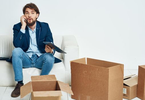 business man sitting on the couch talking on the phone box official. High quality photo