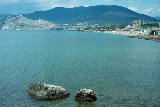 Seascape with rocks on the background of water. Sudak, Crimea