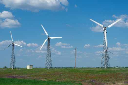Landscape with wind farms on the background of a green field. Donuzlav, Crimea