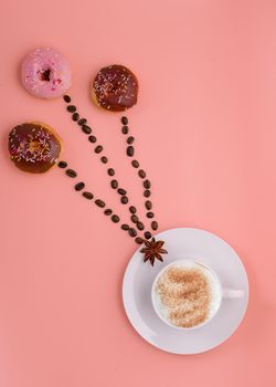 cup of coffee, beans and three doughnut on pink background