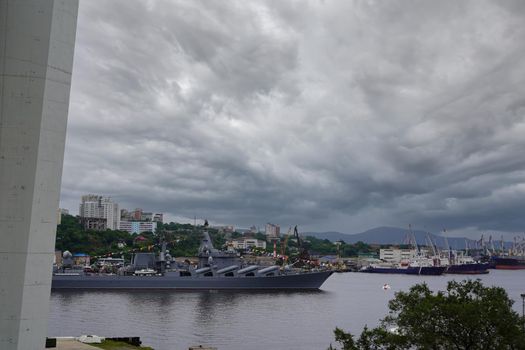 City landscape with a view of a warship under the Golden bridge. Vladivostok, Russia