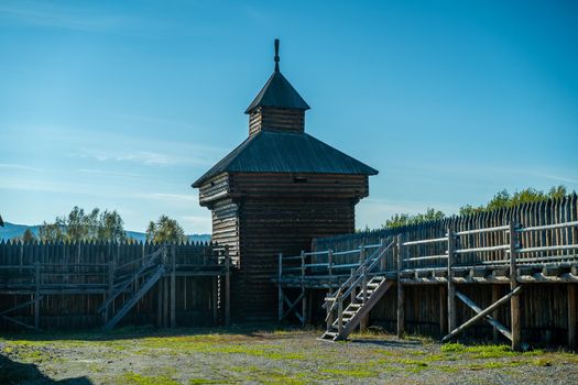 Natural landscape with wooden buildings. Irkutsk region, Taltsy