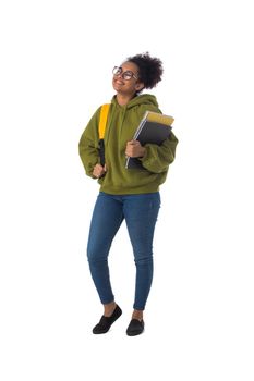 Friendly ethnic black female high school student in eyeglasses with backpack and composition book isolated on white background, full length portrait