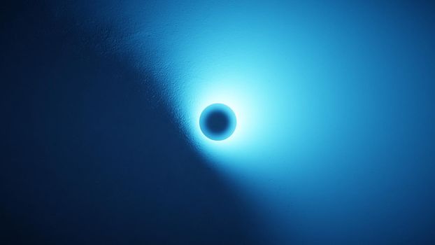 Bright circle of light on a blue textured surface. Abstract background, digital render.