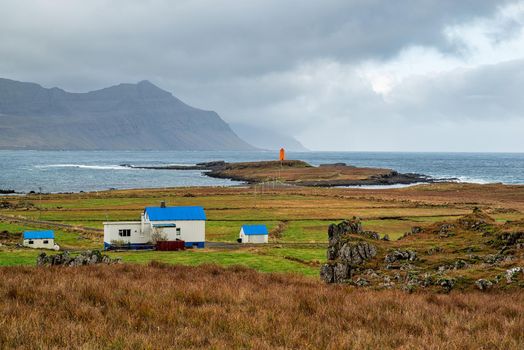 Reydarfjordur on the east side of Iceland and the lighthouse on a cloudy day