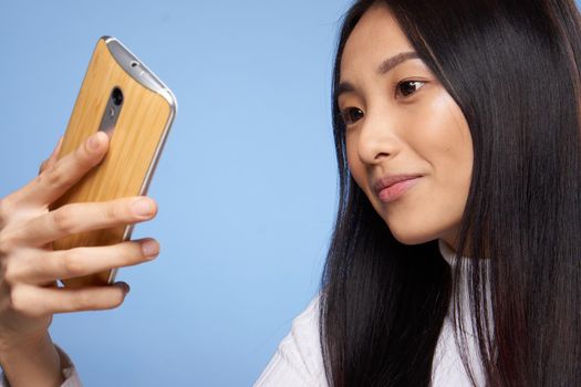 pretty asian woman looking at phone technology communication lifestyle. High quality photo