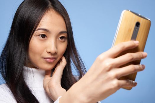 pretty brunette with a phone in her hands the charm of internet communication technology close-up. High quality photo