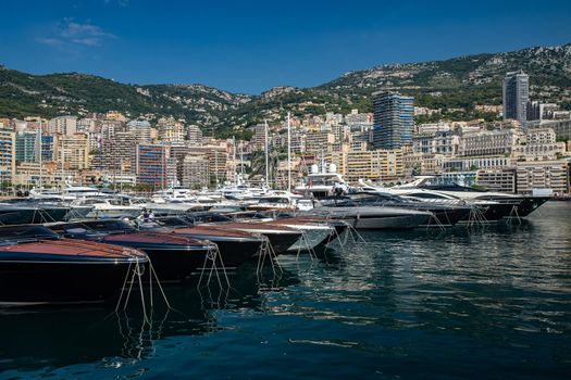 Monaco, Monte-Carlo, 06 August 2018: Tranquillity in port Hercules, is the parked boats, many yachts and boats, RIVA, Prince's Palace of Monaco, megayachts, massif of expensive real estate