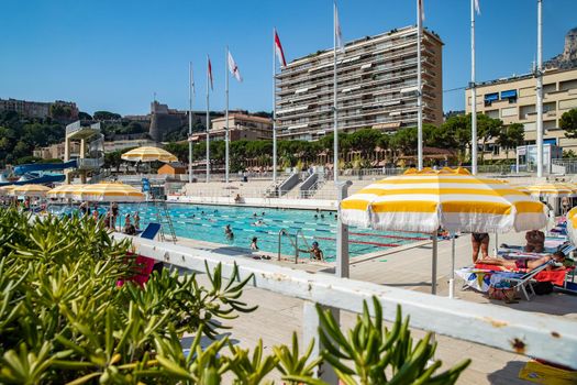 Monaco, Monte-Carlo, 06 August 2018: The famous pool in port Hercules, is the parked boats, a lot of people, Children and elderly people, many yachts and boats, Prince's Palace, megayachts