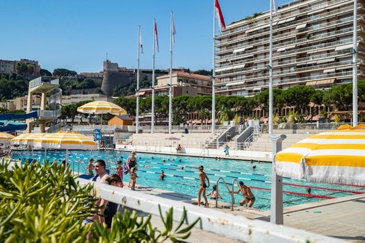 Monaco, Monte-Carlo, 06 August 2018: The famous pool in port Hercules, is the parked boats, a lot of people, Children and elderly people, many yachts and boats, Prince's Palace, megayachts