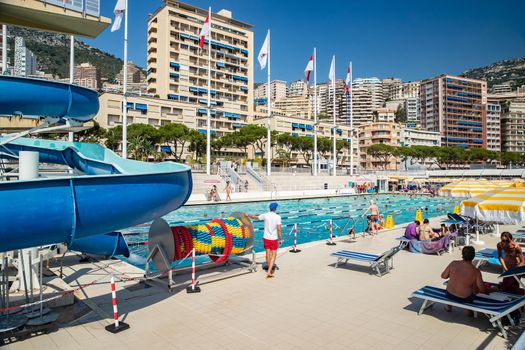 Monaco, Monte-Carlo, 06 August 2018: The famous pool in port Hercules, is the parked boats, a lot of people, Children and elderly people, many yachts and boats, Prince's Palace, megayachts