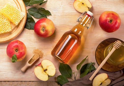 Jewish holiday Rosh Hashana background with apples, honey on blackboard. View from above. Flat lay