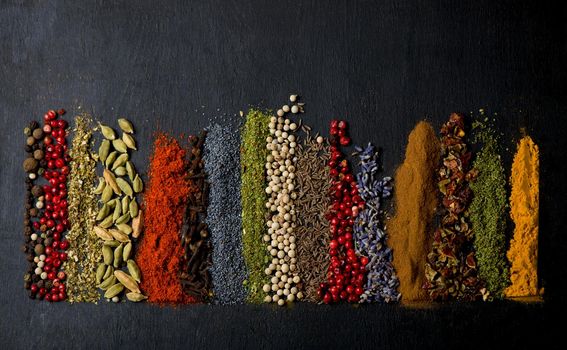 Various spices spoons on table. Top view with copy space