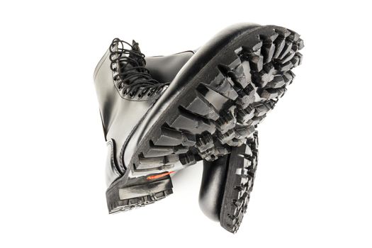 close-up ultra wide angle view of new boots mini lugs black rubber outsole with 120 plus oil resistance grade , isolated on white background